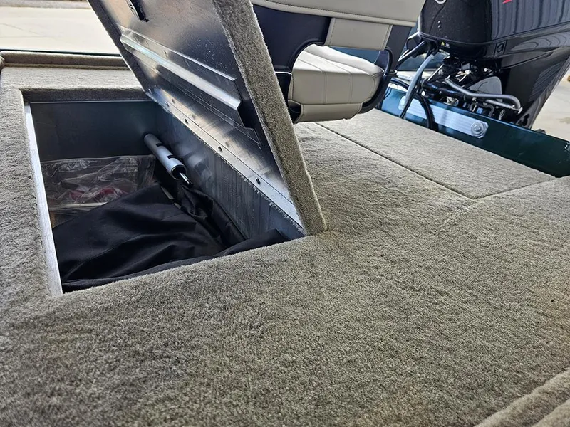 Slide: The Image of 2026 Tracker Bass Tracker Classic Limited boat storage compartment with open lid and visible interior. - 10