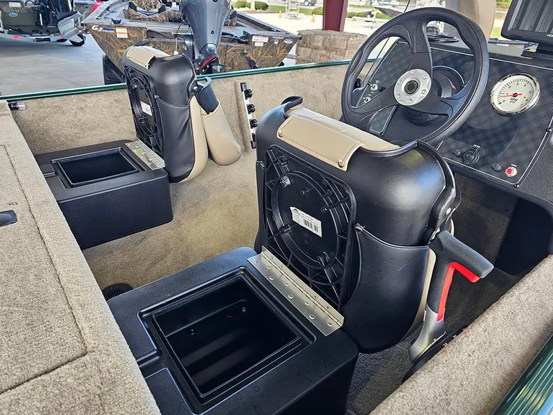 Slide: The Image of 2026 Tracker Bass Tracker Classic Limited boat interior with steering wheel and seating. - 12