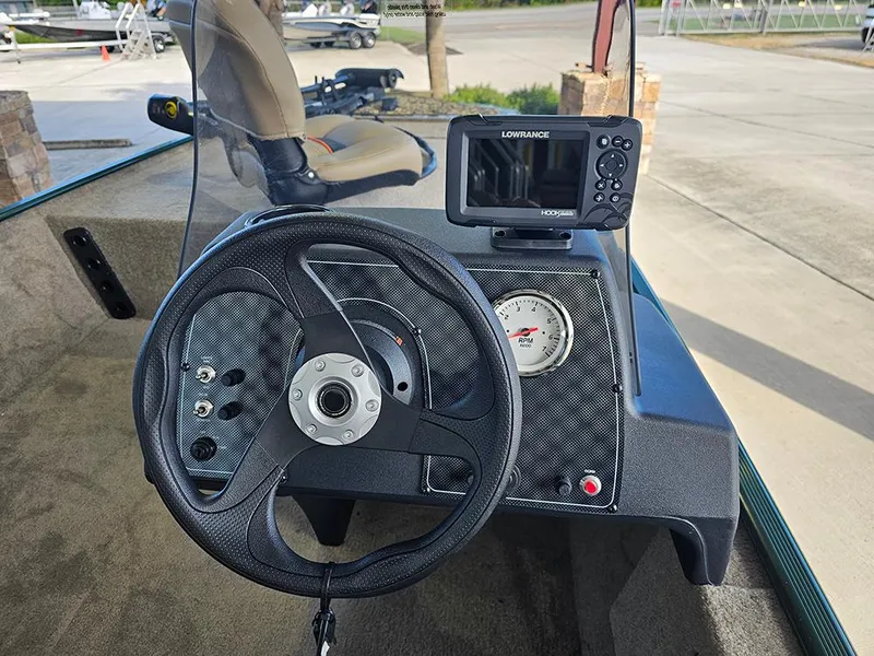 Slide: The Image of 2026 Tracker Bass Tracker Classic Limited dashboard with steering wheel and Lowrance fish finder. - 13
