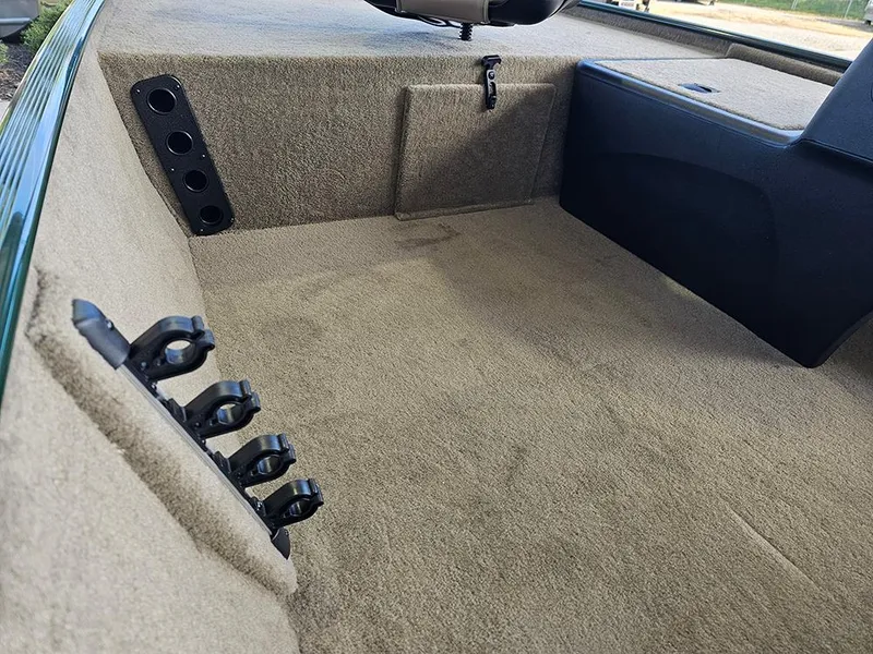 Slide: The Image of Interior of 2026 Tracker Bass Tracker Classic Limited boat with rod holders and carpeted flooring. - 17