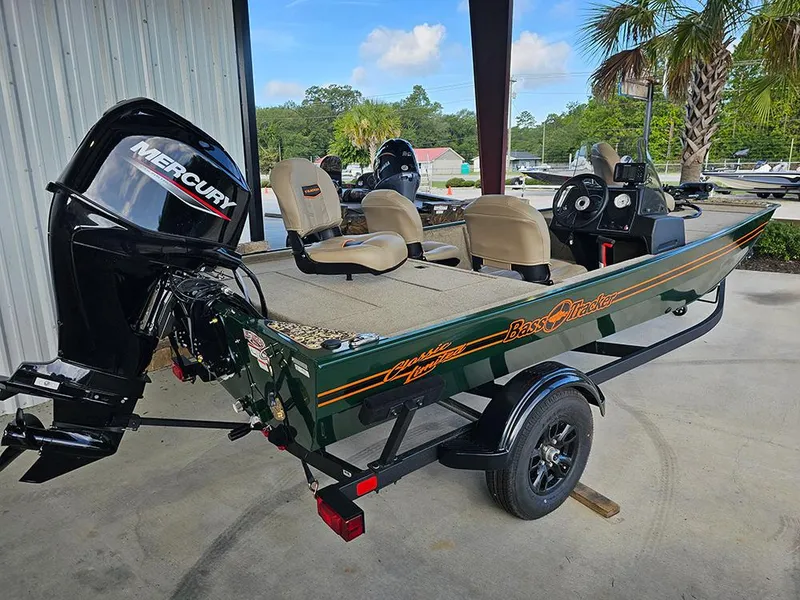 Slide: The Image of 2026 Tracker Bass Tracker Classic Limited boat with Mercury engine, parked outdoors. - 3