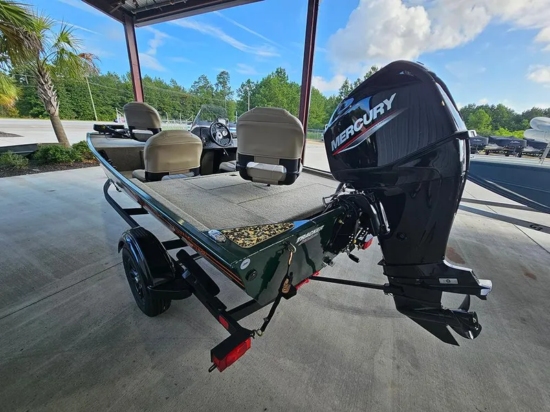 Slide: The Image of 2026 Tracker Bass Tracker Classic Limited boat with Mercury engine, parked under a canopy. - 7