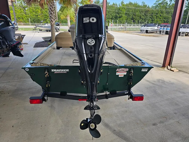 Slide: The Image of 2026 Tracker Bass Tracker Classic Limited boat with Mercury 50 engine, parked outdoors. - 8