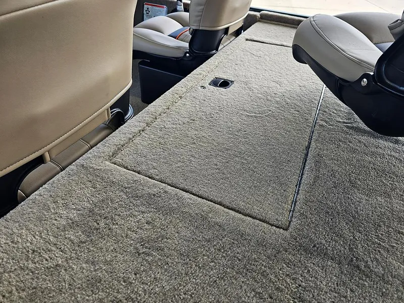 Slide: The Image of 2026 Tracker Bass Tracker Classic Limited interior with beige carpet and seating. - 9