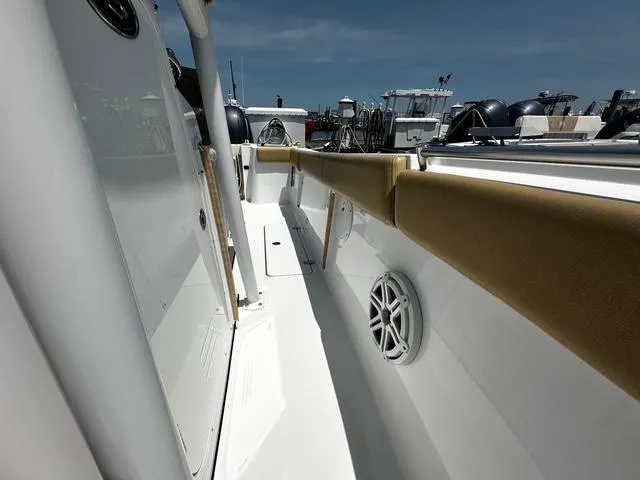 Slide: The Image of 2018 Sportsman Open 252 Center Console boat interior with cushioned seating and speaker. - 11