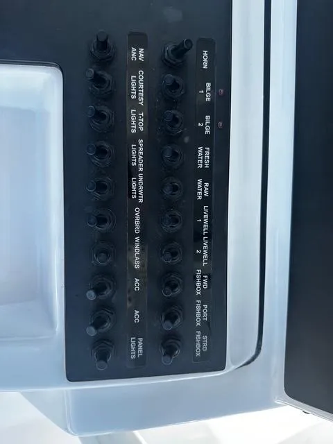 Slide: The Image of Control panel of a 2018 Sportsman Open 252 Center Console boat with labeled switches. - 15