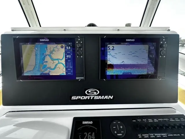 Slide: The Image of 2018 Sportsman Open 252 Center Console dashboard with dual Simrad navigation displays. - 17
