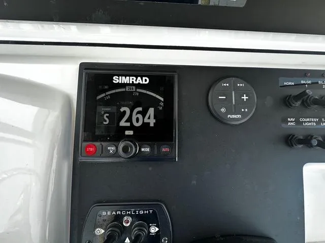 Slide: The Image of Control panel of a 2018 Sportsman Open 252 Center Console boat with Simrad display. - 18