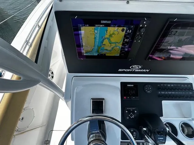 Slide: The Image of 2018 Sportsman Open 252 Center Console dashboard with Simrad navigation display. - 20