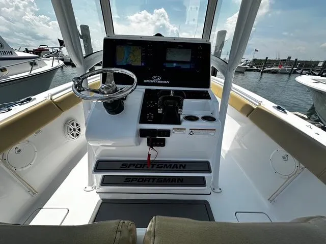 Slide: The Image of 2018 Sportsman Open 252 Center Console boat interior with steering wheel and navigation screens. - 21