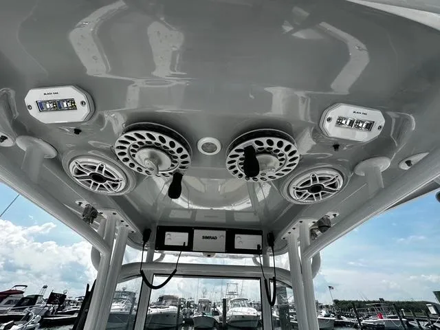 Slide: The Image of 2018 Sportsman Open 252 Center Console boat speakers and controls on overhead console. - 24
