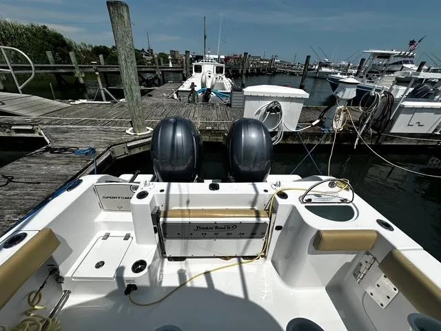 Slide: The Image of 2018 Sportsman Open 252 Center Console boat docked at marina with twin engines. - 28