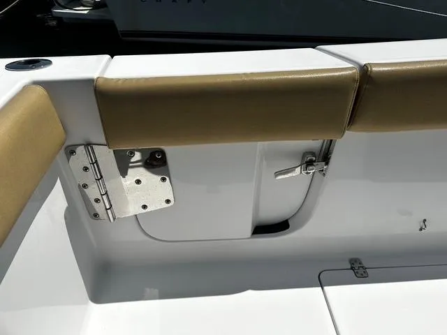 Slide: The Image of 2018 Sportsman Open 252 Center Console boat interior with tan cushioned seating and stainless steel hardware. - 31