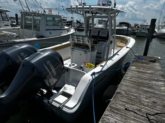 Slide: The Image of 2018 Sportsman Open 252 Center Console boat docked with twin Yamaha engines. - 35
