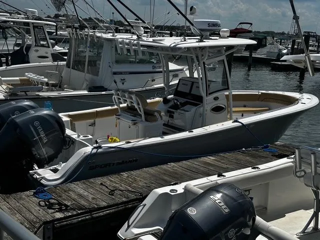 Slide: The Image of 2018 Sportsman Open 252 Center Console boat docked at marina with twin Yamaha engines. - 36