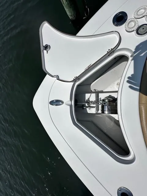 Slide: The Image of 2018 Sportsman Open 252 Center Console boat anchor compartment open on water. - 6