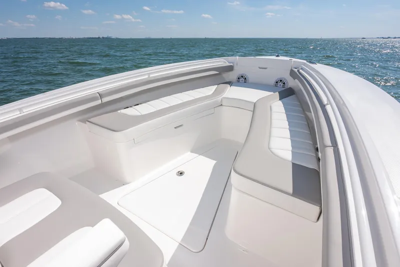 Slide: The Image of 2026 Regulator 23 boat interior with cushioned seating, on a sunny day at sea. - 21