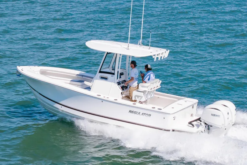 Slide: The Image of 2026 Regulator 23 boat cruising on open water with two passengers. - 3