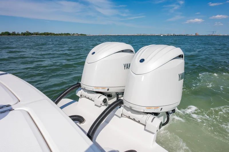 Slide: The Image of 2026 Regulator 23 boat with dual Yamaha outboard engines on open water. - 15