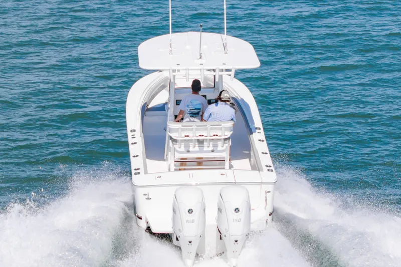 Slide: The Image of 2026 Regulator 23 boat cruising on open water with dual engines. - 5