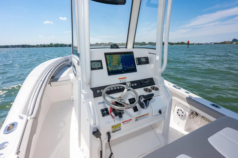 Slide: The Image of 2026 Regulator 23 boat dashboard with navigation system on open water. - 18