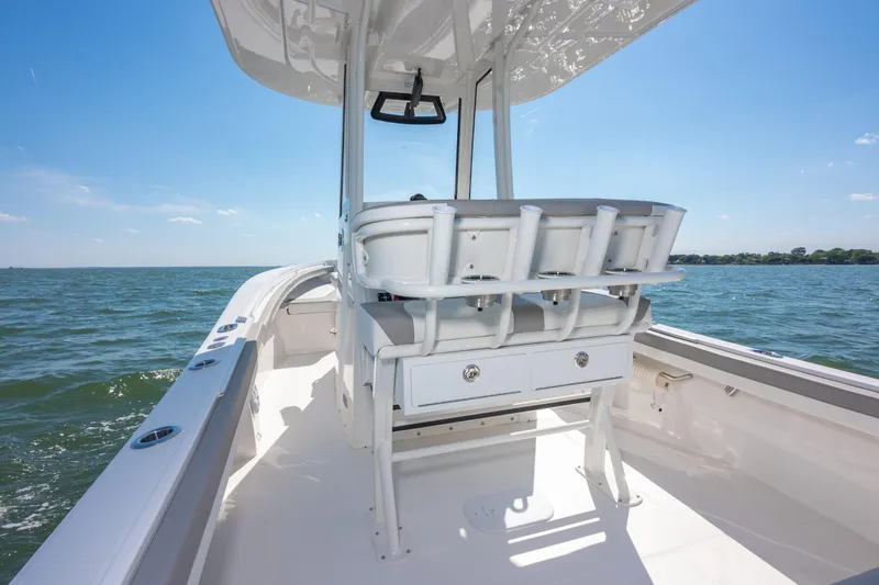 Slide: The Image of 2026 Regulator 23 boat interior with seating, on a sunny day at sea. - 10