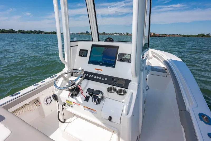 Slide: The Image of 2026 Regulator 23 boat cockpit with modern navigation system on open water. - 19