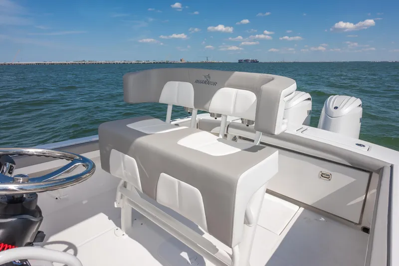 Slide: The Image of 2026 Regulator 23 boat interior with dual engines on open water. - 16