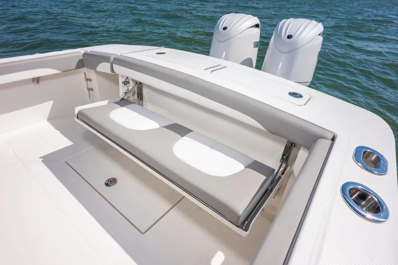 Slide: The Image of 2026 Regulator 23 boat with foldable seating and dual outboard motors on the water. - 13
