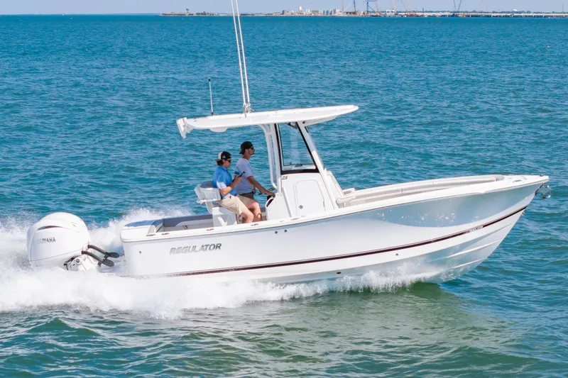 Slide: The Image of 2026 Regulator 23 boat cruising on open water with two passengers. - 8