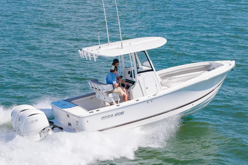 Slide: The Image of 2026 Regulator 23 boat cruising on open water with two passengers. - 7
