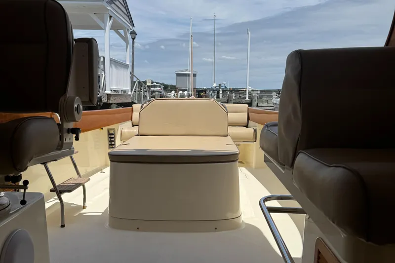 Slide: The Image of Interior of a 1999 Hinckley Picnic boat with beige seating and wooden accents. - 10