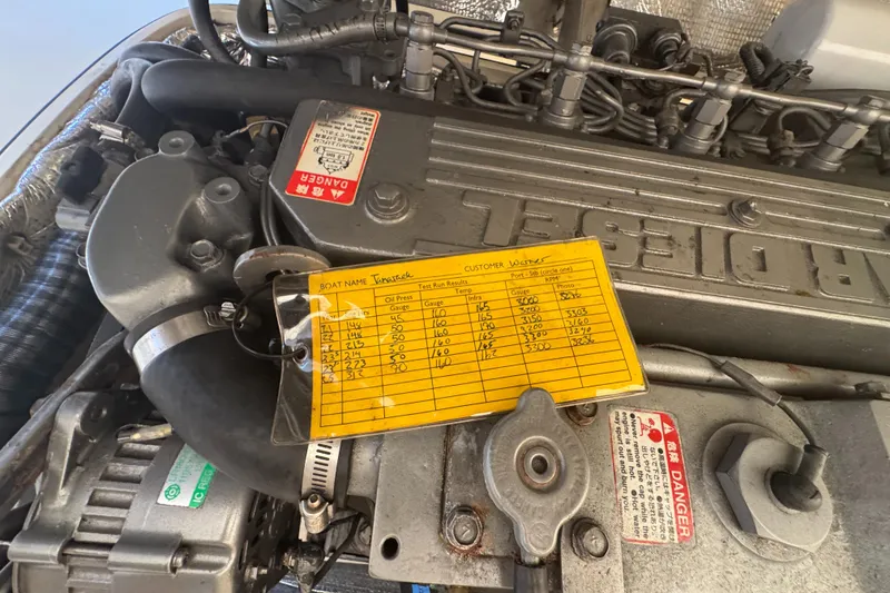 Slide: The Image of Engine of a 1999 Hinckley Picnic boat with maintenance log attached. - 18