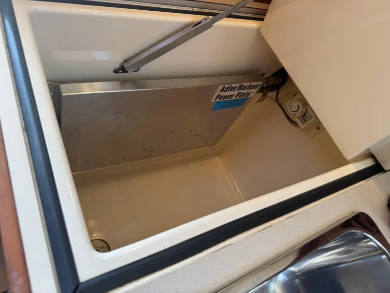 Slide: The Image of Open storage compartment in 1999 Hinckley Picnic boat with Adler Barbour Power Plate. - 20