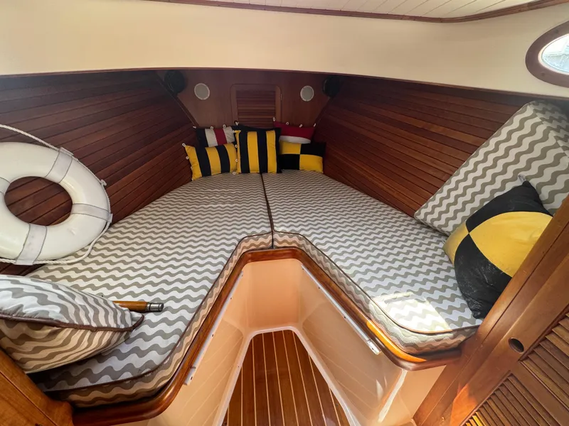 Slide: The Image of Cozy cabin interior of 1999 Hinckley Picnic boat with striped cushions and colorful pillows. - 21