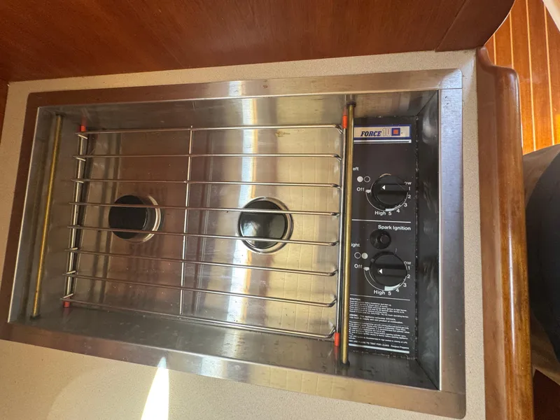 Slide: The Image of Stainless steel stove in 1999 Hinckley Picnic boat galley, featuring dual burners and control knobs. - 23
