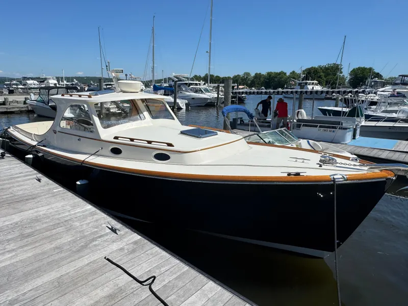Slide: The Image of 1999 Hinckley Picnic boat docked at a marina on a sunny day. - 4