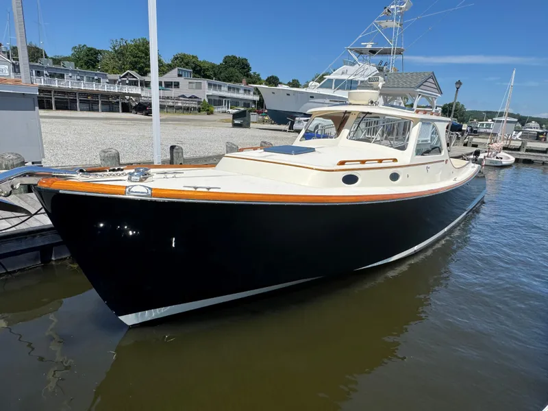 Slide: The Image of 1999 Hinckley Picnic boat docked at a marina under clear blue skies. - 5