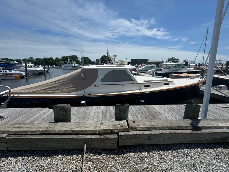 Slide: The Image of 1999 Hinckley Picnic boat docked at a marina under a clear blue sky. - 7