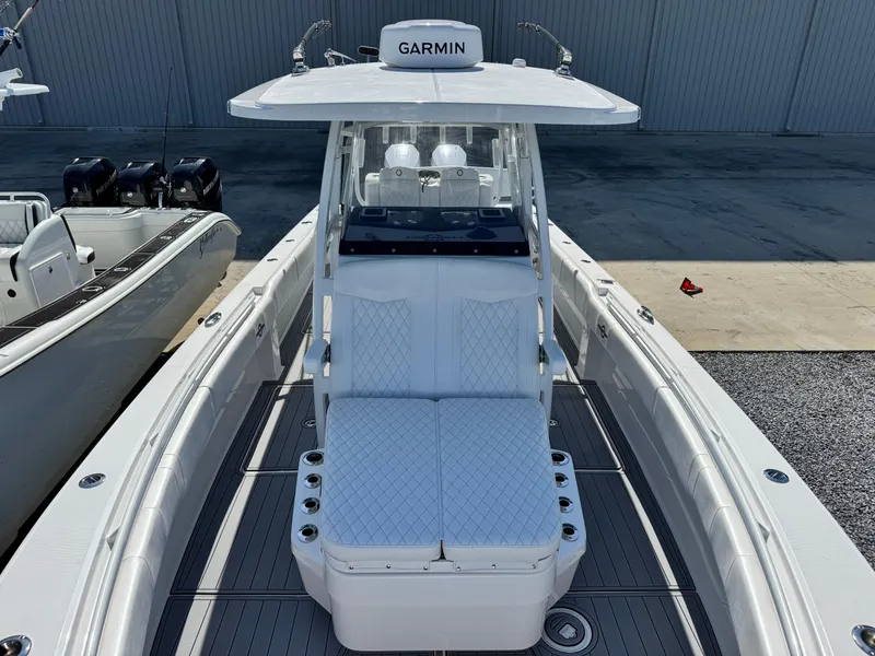 Slide: The Image of 2025 Fountain 34 TE boat with Garmin equipment, featuring sleek white seating and modern design. - 10