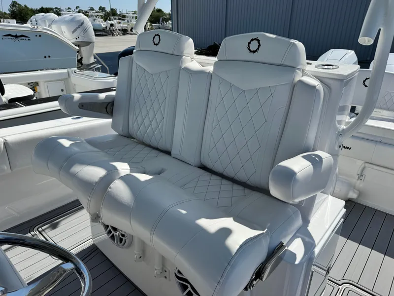 Slide: The Image of Luxurious white seating on 2025 Fountain 34 TE boat, featuring diamond stitching and armrests. - 12
