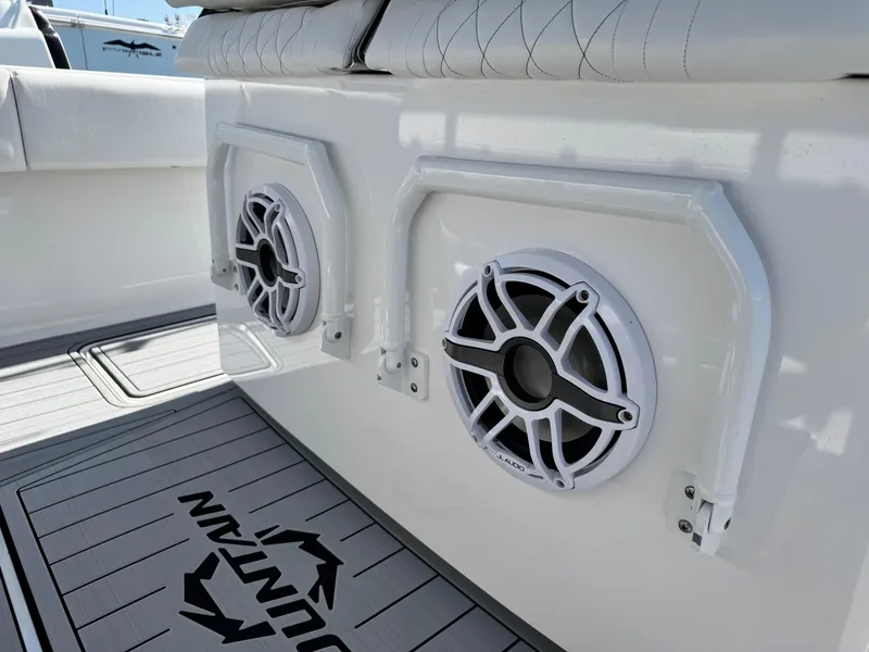 Slide: The Image of 2025 Fountain 34 TE boat interior with JL Audio speakers and cushioned seating. - 13