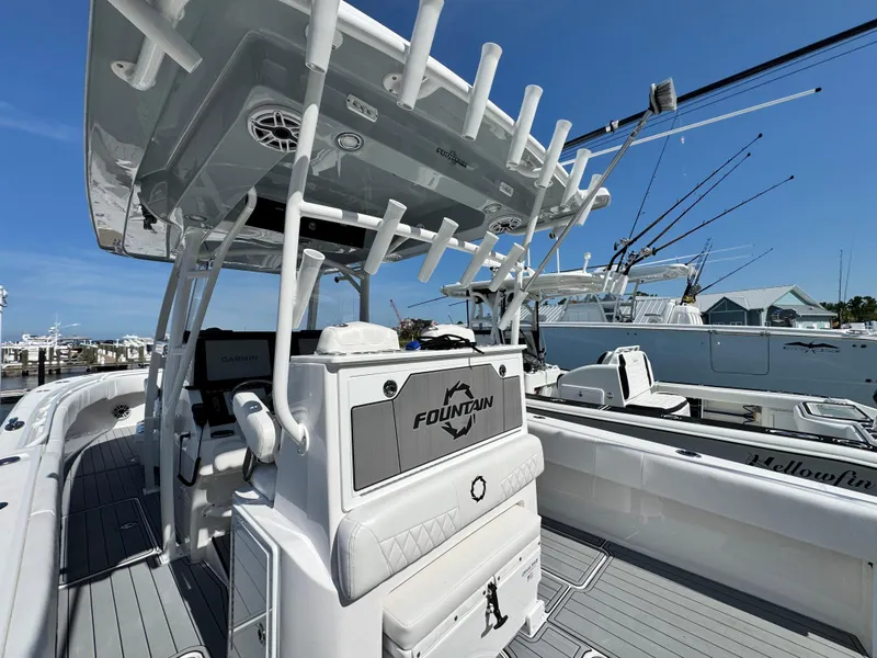 Slide: The Image of 2025 Fountain 34 TE boat with advanced fishing equipment and sleek design at a marina. - 17