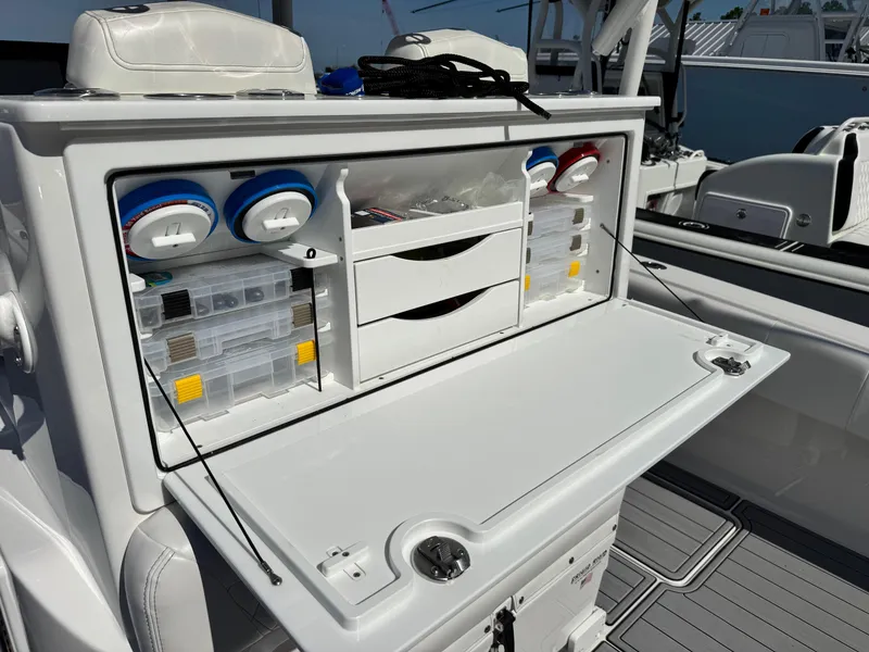 Slide: The Image of 2025 Fountain 34 TE boat with open storage compartment and organized fishing gear. - 18