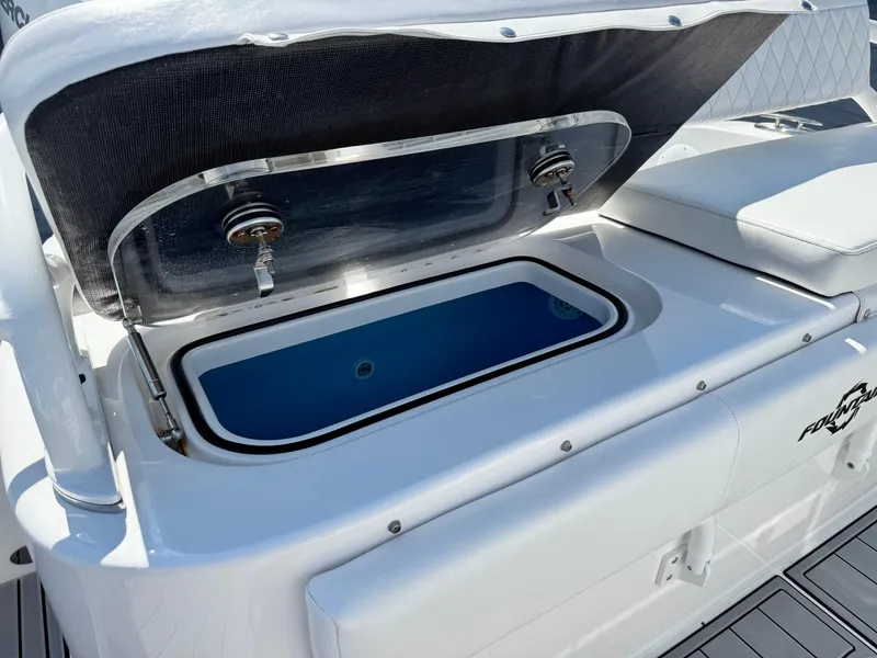 Slide: The Image of Open storage compartment on 2025 Fountain 34 TE boat, featuring sleek white design. - 21