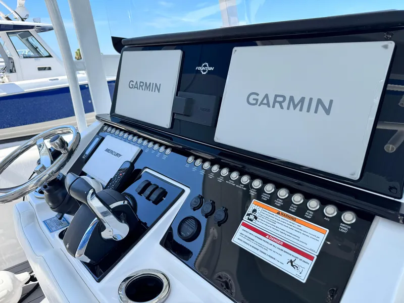 Slide: The Image of Control panel of 2025 Fountain 34 TE boat with Garmin displays and steering wheel. - 26