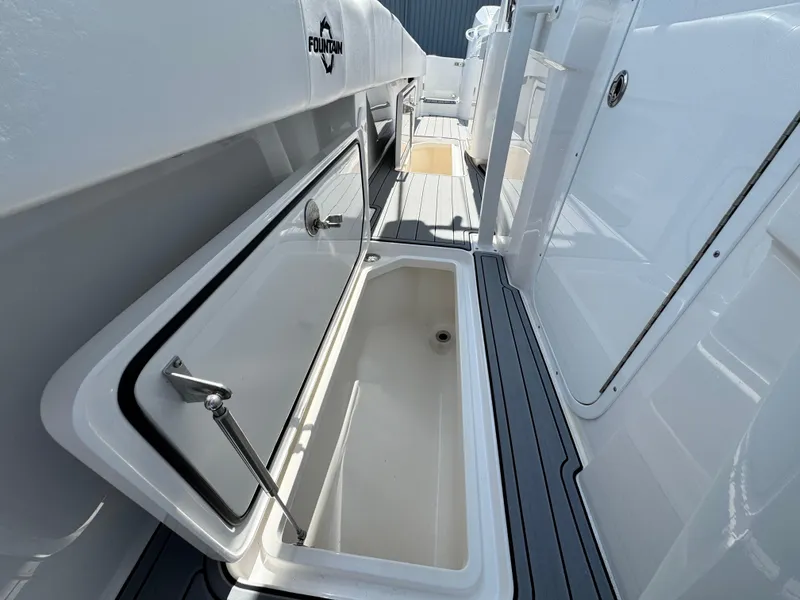 Slide: The Image of 2025 Fountain 34 TE boat interior with open storage compartment, sleek design. - 28