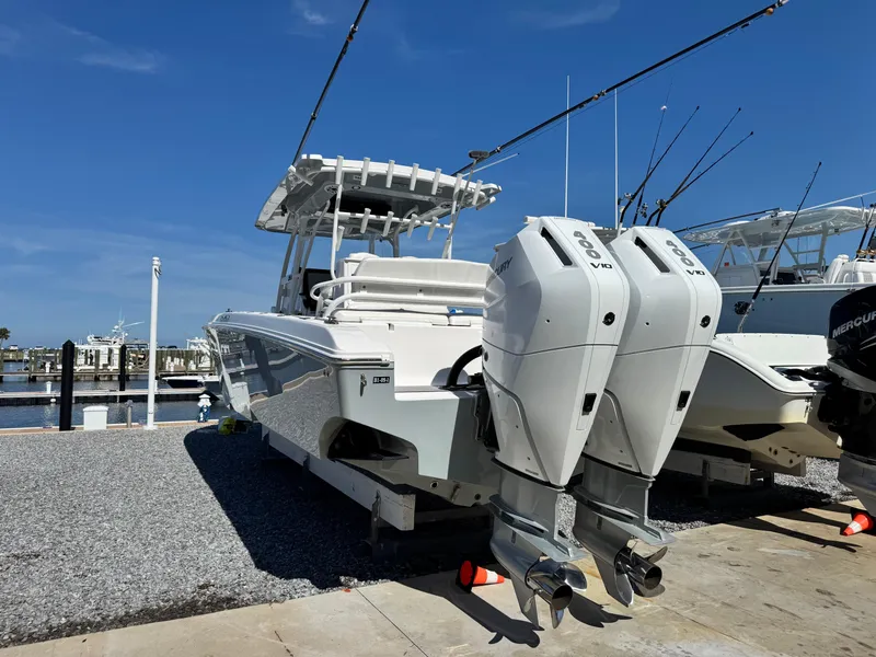 Slide: The Image of 2025 Fountain 34 TE boat with dual Mercury outboard engines at a marina. - 4