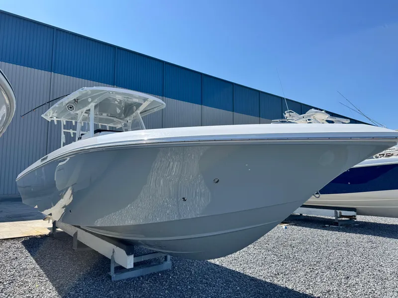 Slide: The Image of 2025 Fountain 34 TE boat displayed outdoors on gravel, under clear blue sky. - 7