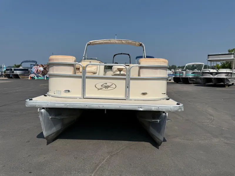 The Image of 2006 Sweetwater 23860DF pontoon boat parked on asphalt under clear sky. - 1